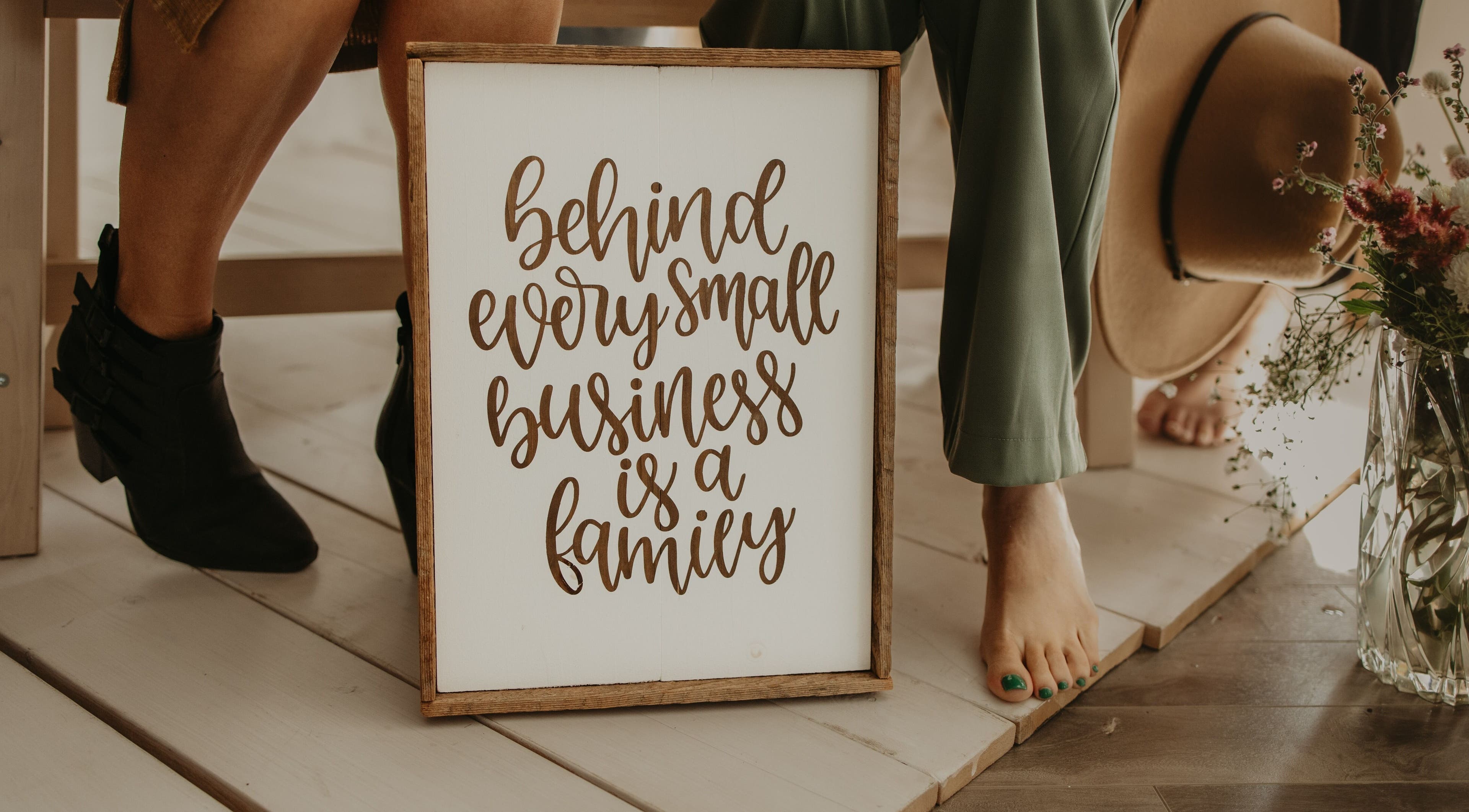 A sign reading 'Behind every small business is a family' at Purity Relaxation & Beauty Spa, Redvers, Saskatchewan, CA.