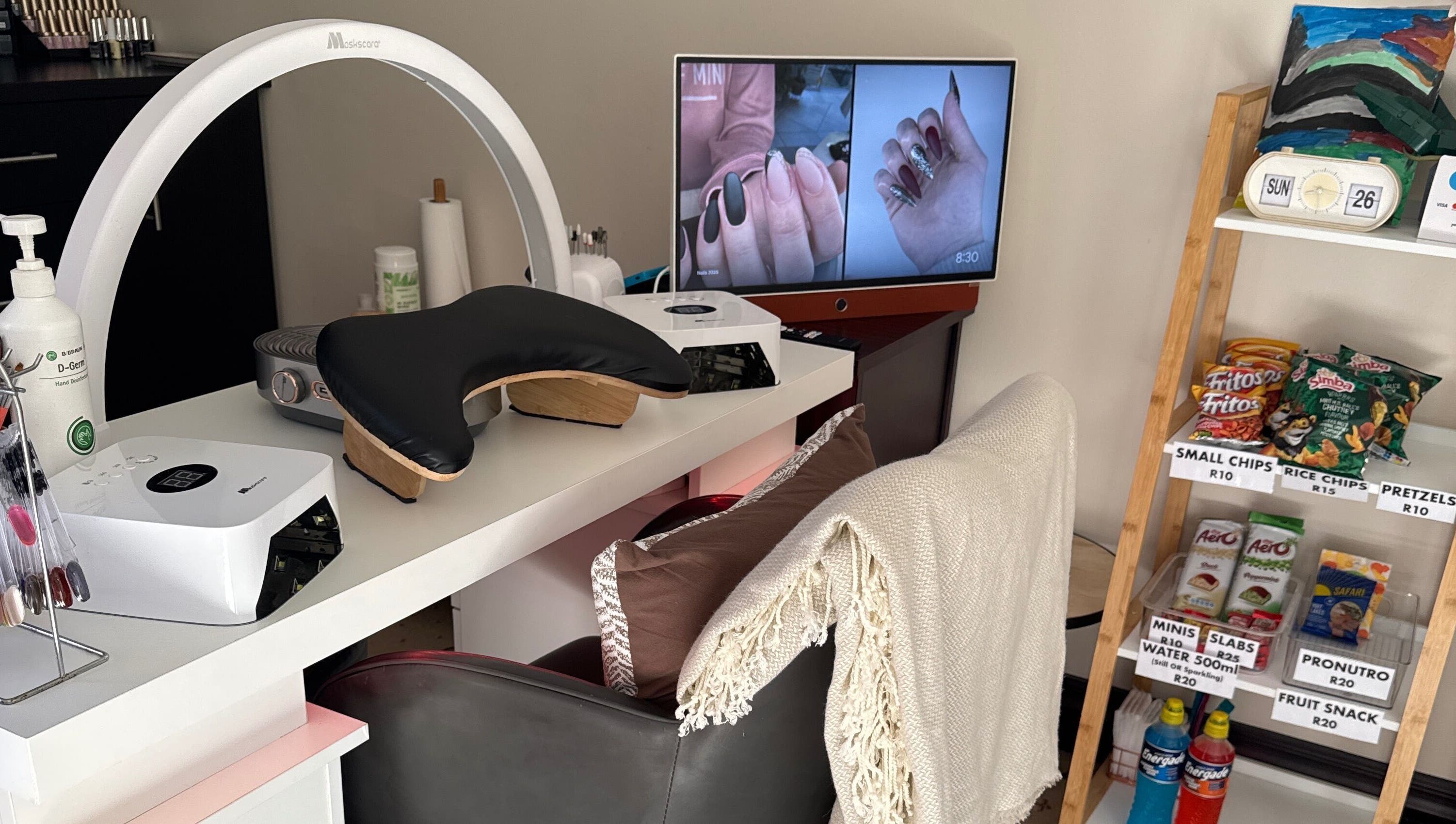 Modern nail station at Nails by Lara in Gqeberha, Eastern Cape, ZA with snacks and nail art display.