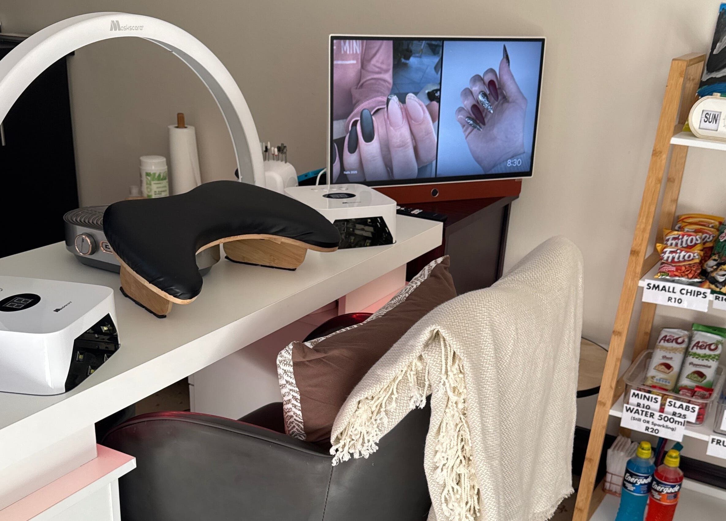 Modern nail station at Nails by Lara in Gqeberha, Eastern Cape, ZA with snacks and nail art display.