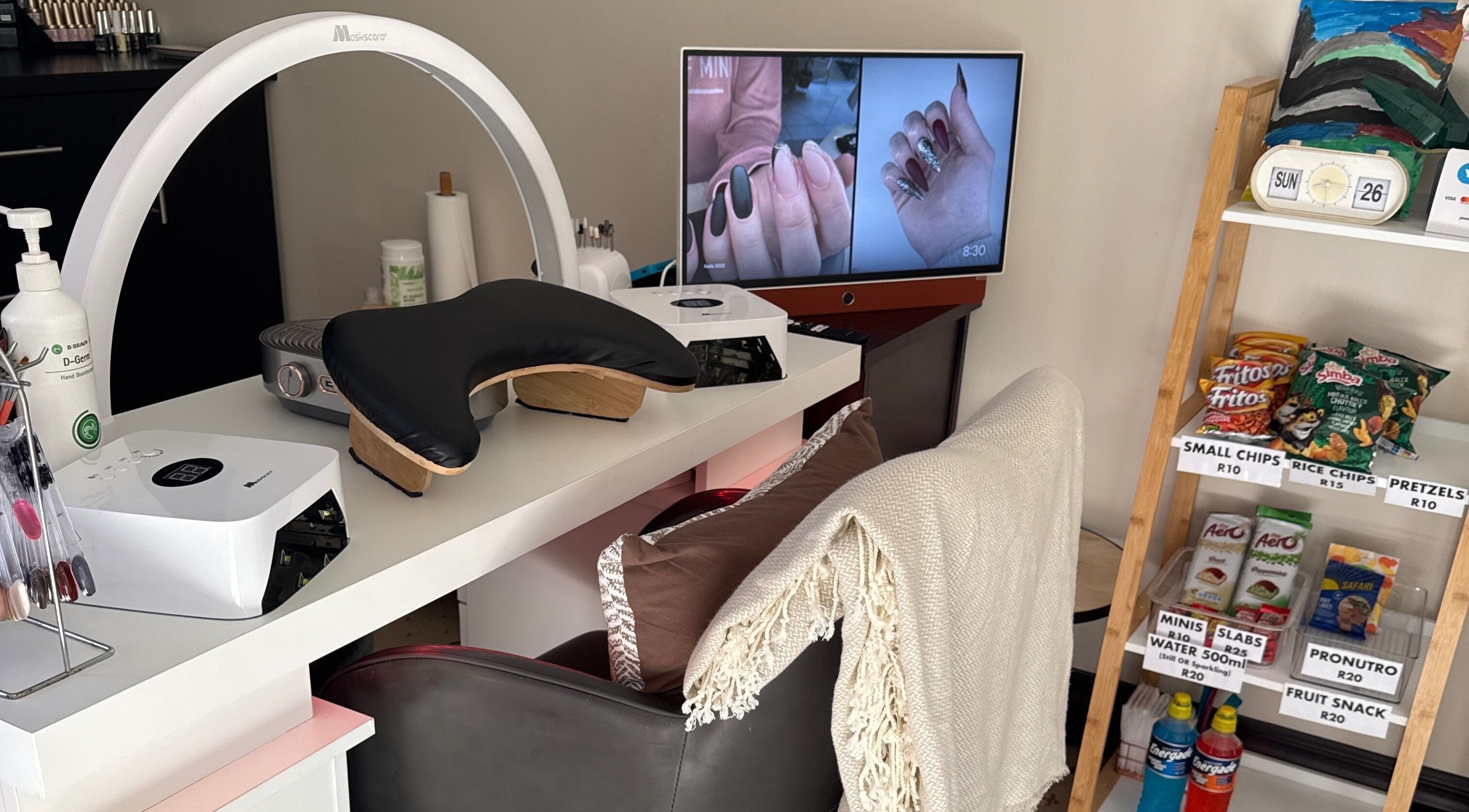 Modern nail station at Nails by Lara in Gqeberha, Eastern Cape, ZA with snacks and nail art display.