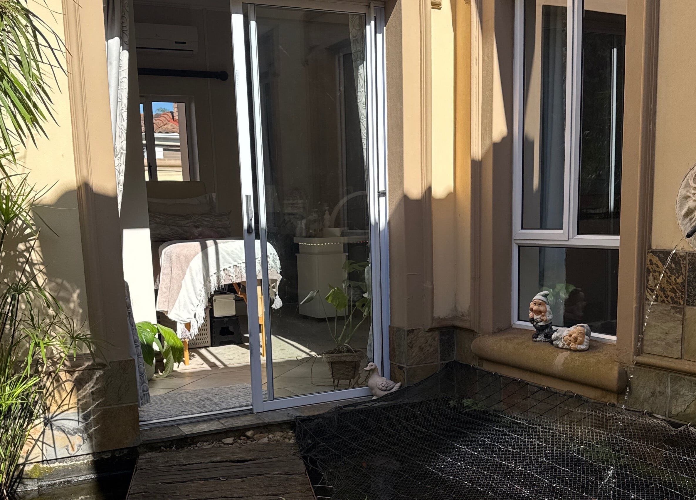 Peaceful patio view at Nails by Lara, Gqeberha, Eastern Cape, ZA with greenery and whimsical decor.