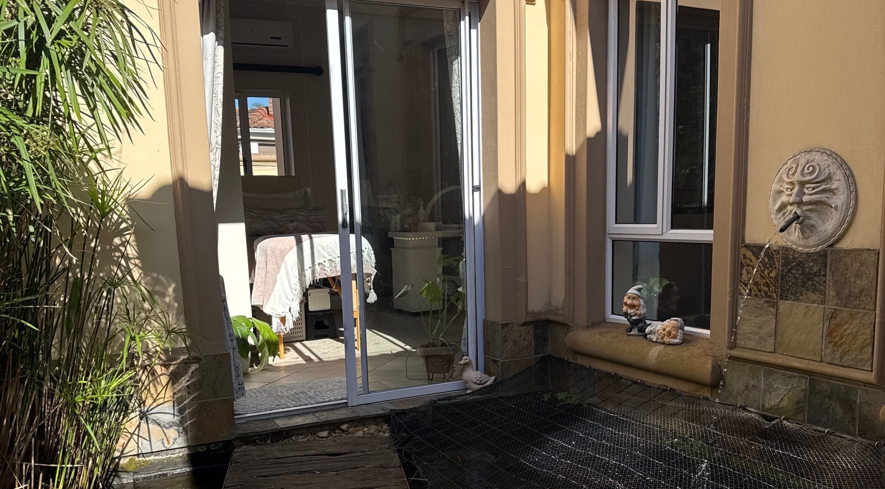 Peaceful patio view at Nails by Lara, Gqeberha, Eastern Cape, ZA with greenery and whimsical decor.