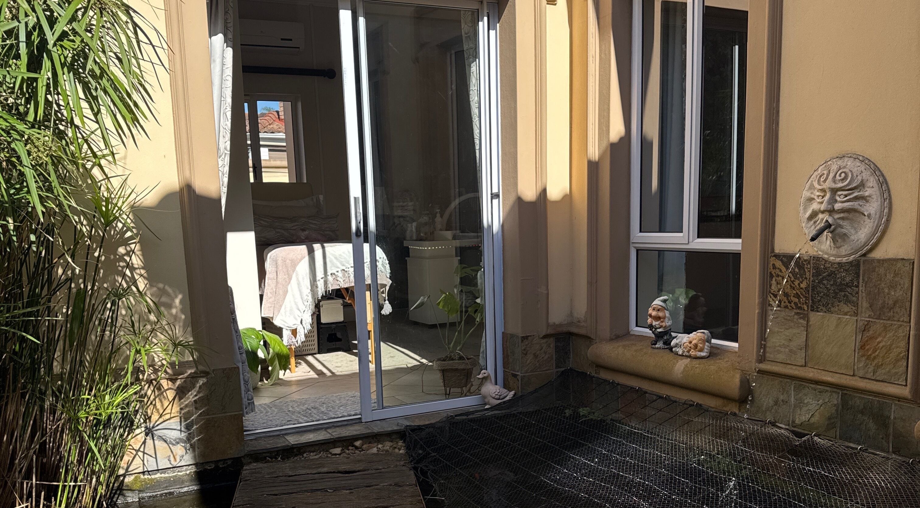 Peaceful patio view at Nails by Lara, Gqeberha, Eastern Cape, ZA with greenery and whimsical decor.