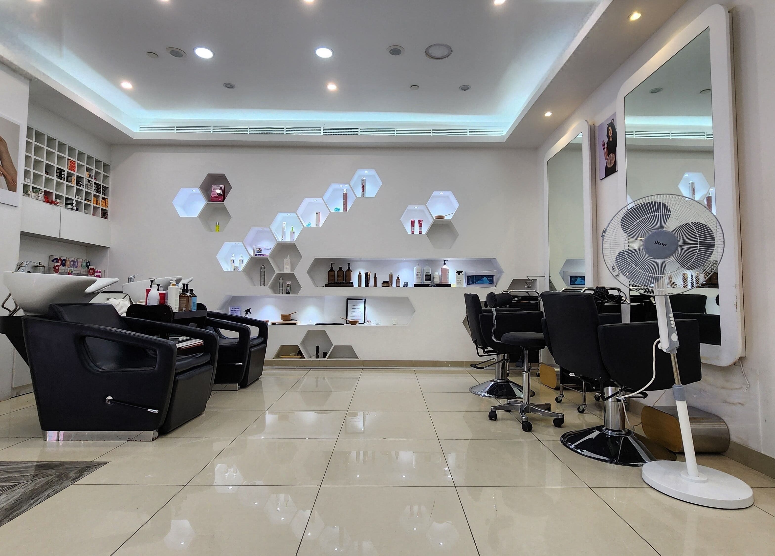 Modern salon interior at Cut and Colours Beauty Center, Abu Dhabi, featuring sleek chairs and stylish decor.