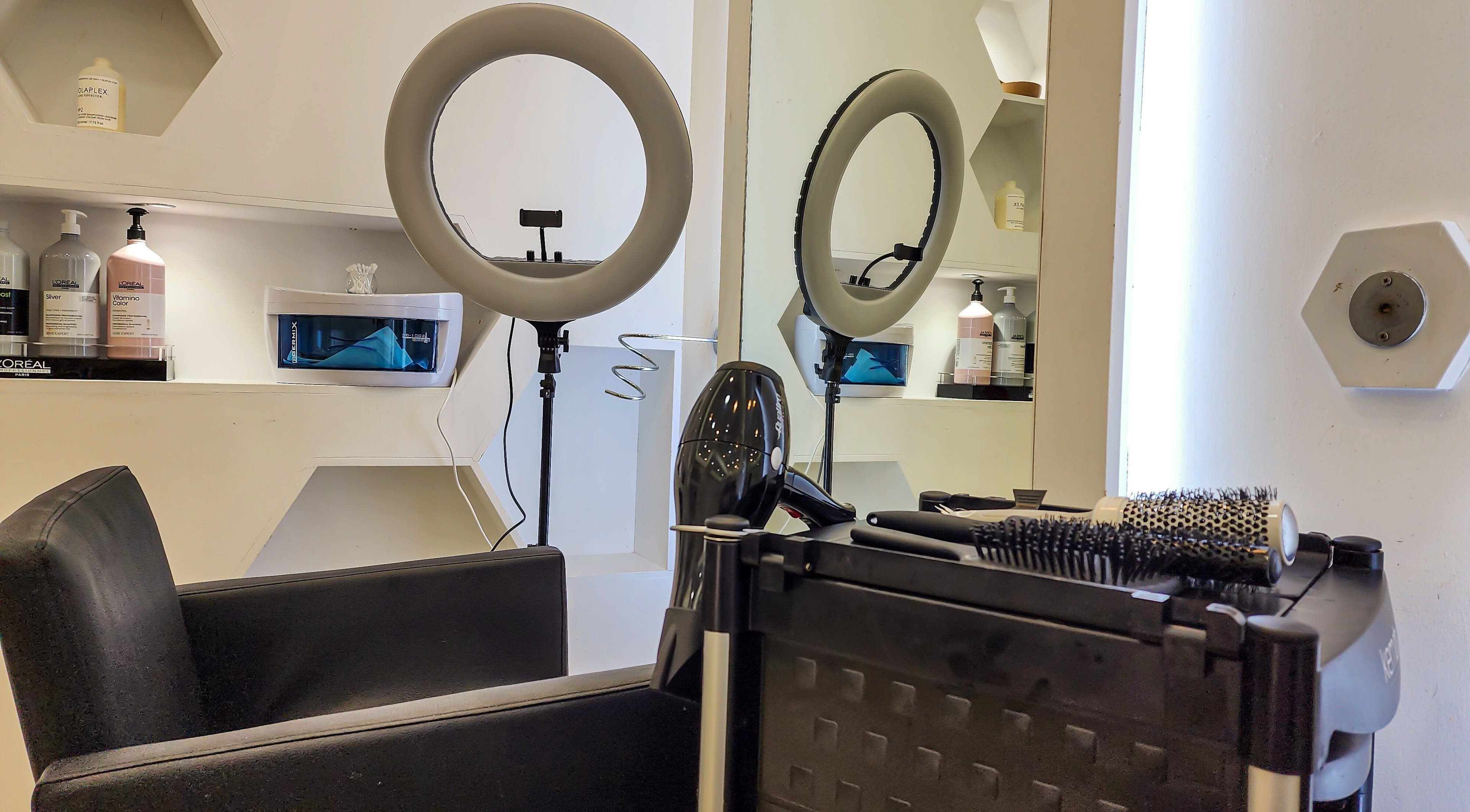 Cut and Colours Beauty Center in Abu Dhabi features a sleek salon chair and ring light setup.