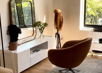 Modern salon corner at Frontrow Hair in Cape Town, Western Cape, ZA with sleek chair and mannequin heads.