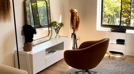 Modern salon corner at Frontrow Hair in Cape Town, Western Cape, ZA with sleek chair and mannequin heads.