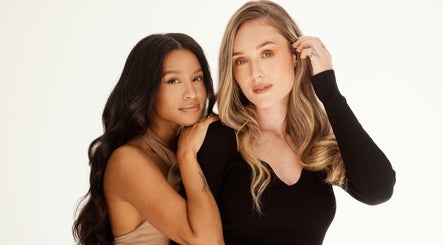 Two women showcasing hairstyles at Frontrow Hair, Cape Town, Western Cape, ZA. Elegant beauty.