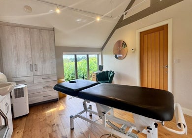 Relaxing treatment room at KK Clinic in Ashby-de-la-Zouch, England, GB with a massage table and modern decor.