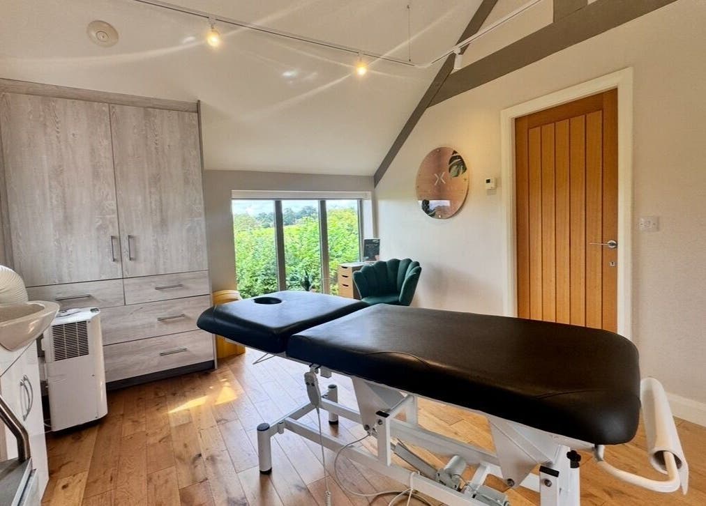 Elegant treatment room at KK Clinic in Ashby-de-la-zouch, England, GB with massage table and tranquil decor.