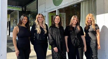 Team of stylists smiling outside Tuca Salon, Melbourne, Victoria, AU.