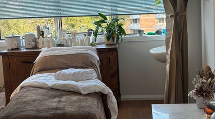 Tranquil treatment room at Brows by Britt, Wollongong, New South Wales, AU, with spa essentials and plants.