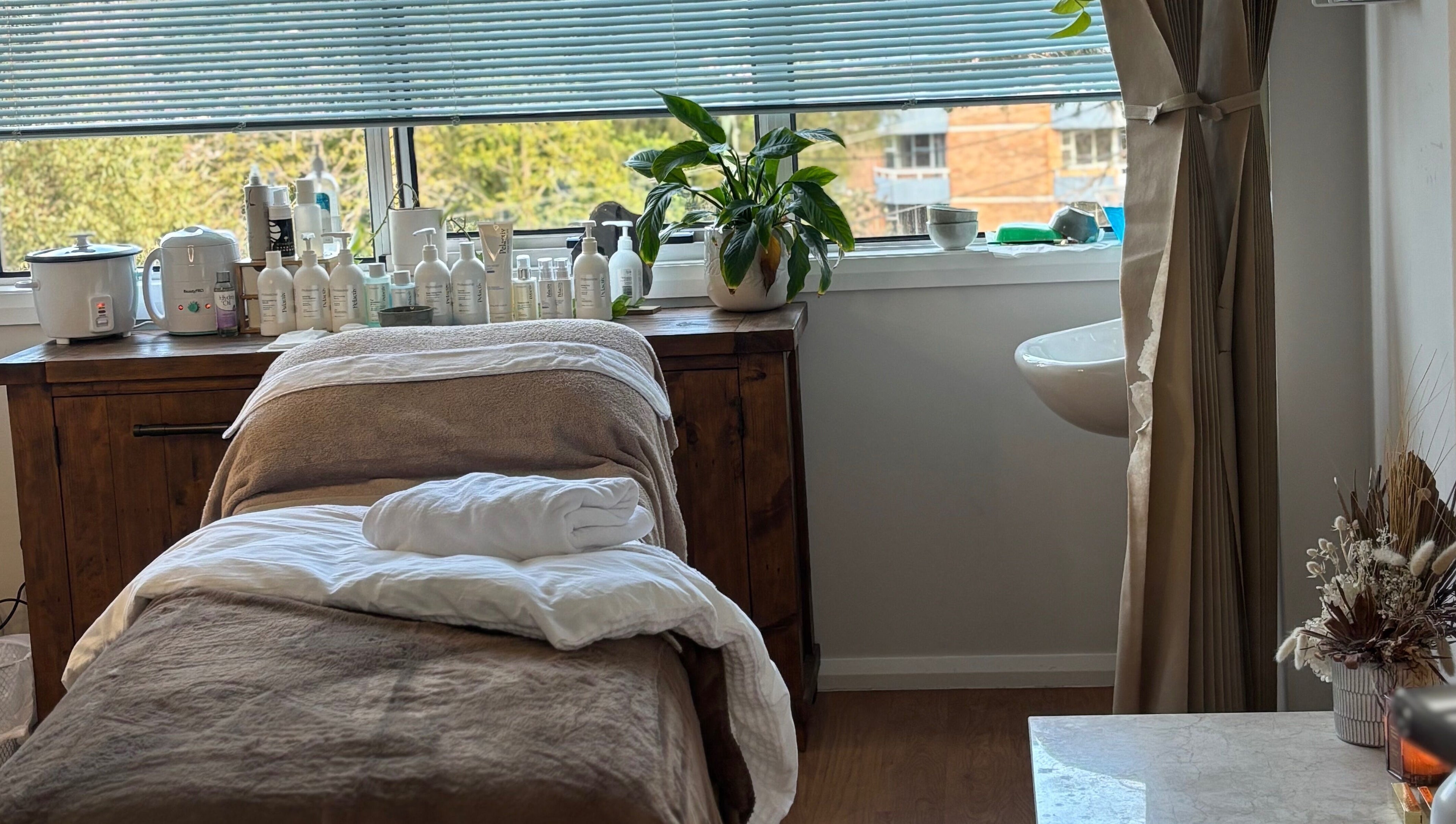 Elegant spa room at Brows by Britt, Wollongong, New South Wales, AU, with treatment bed and natural light.