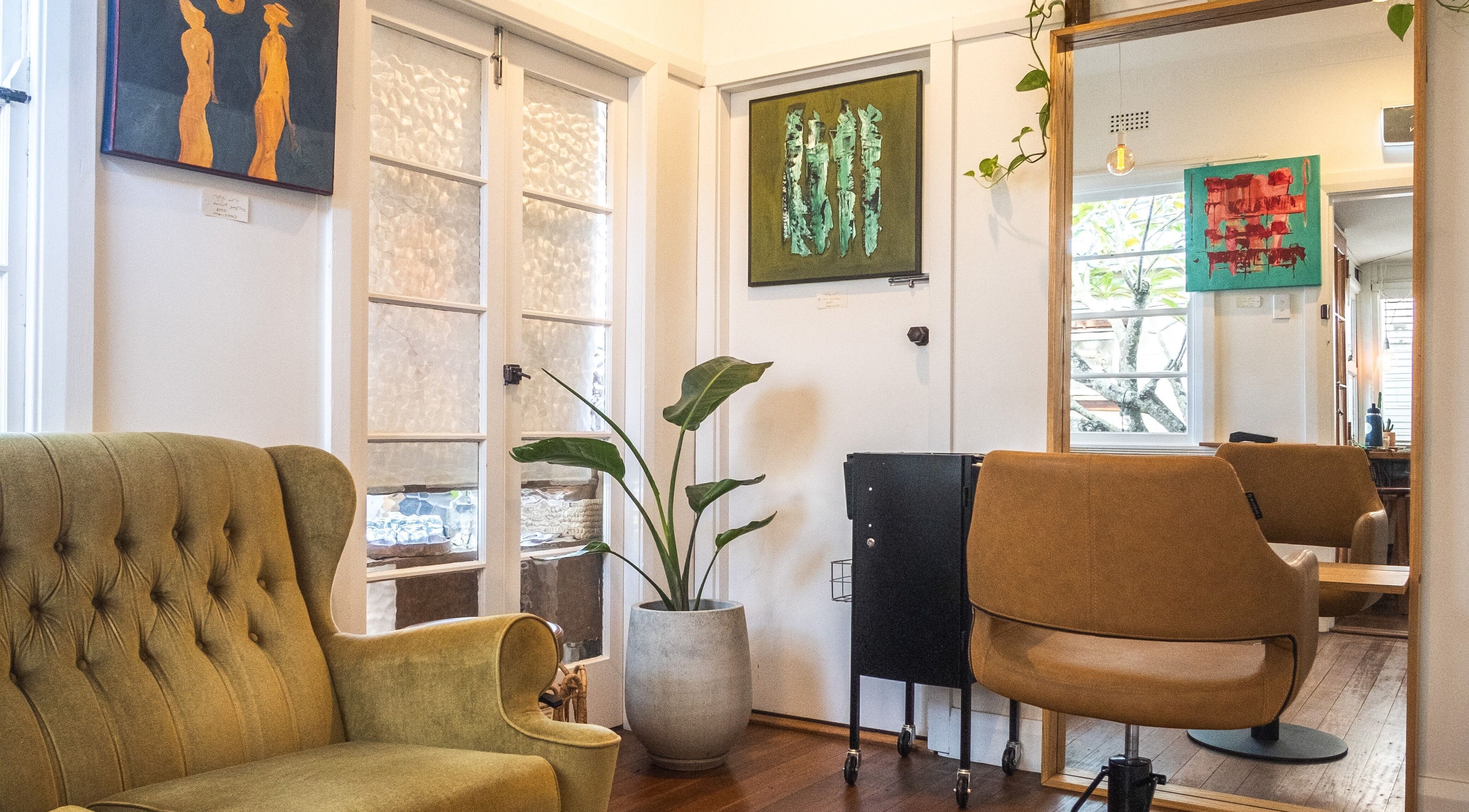 Stylish seating area with art decor at EmlouiseHair - Colourist / Stylist, Mullumbimby, New South Wales, AU.