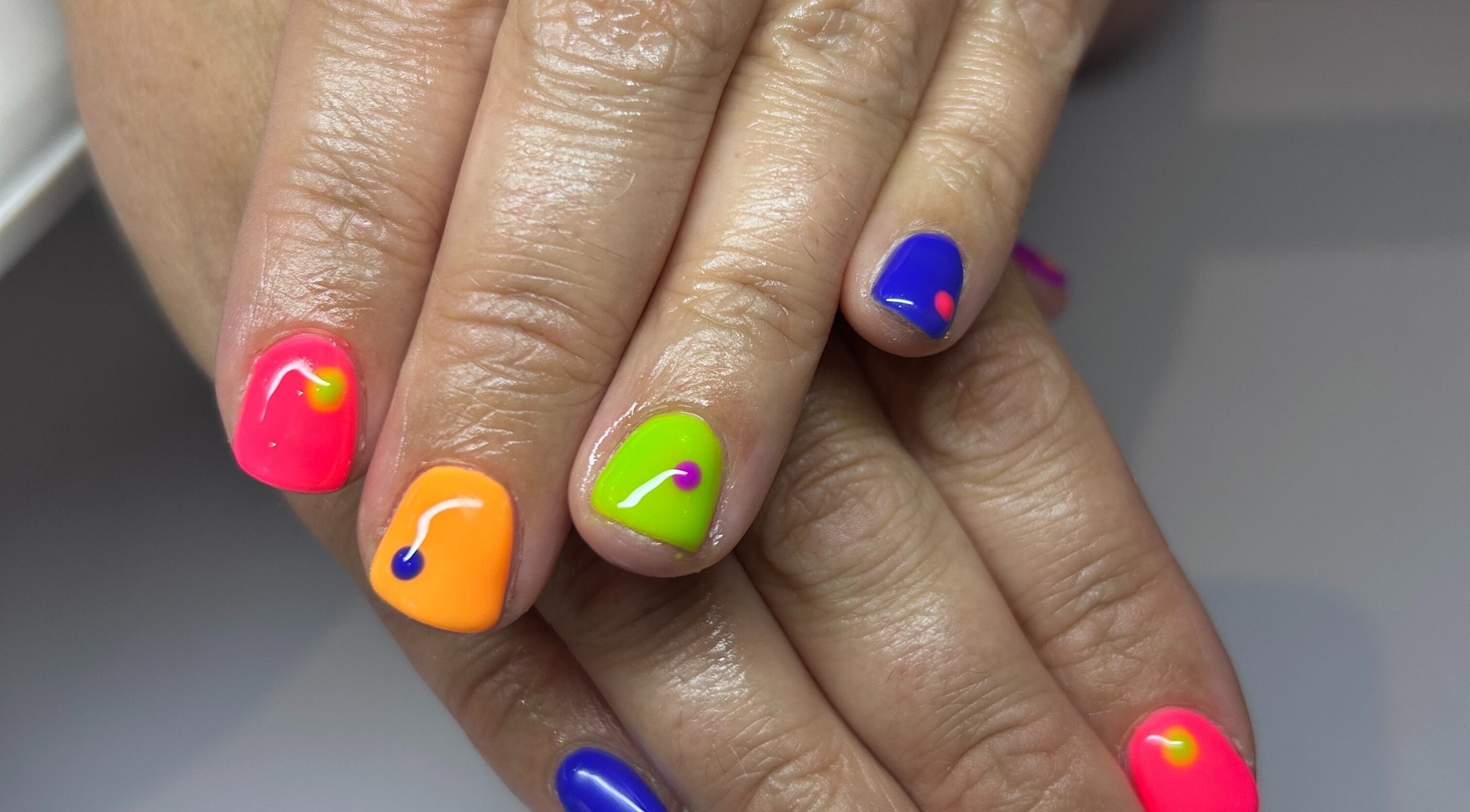 Colorful nail art at Bridie’s Beauty, Kessingland, England featuring neon shades.