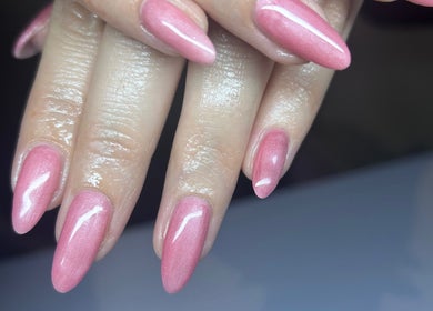 Elegant pink manicure at Bridie’s Beauty, Kessingland, England, GB showcasing glossy nail art.