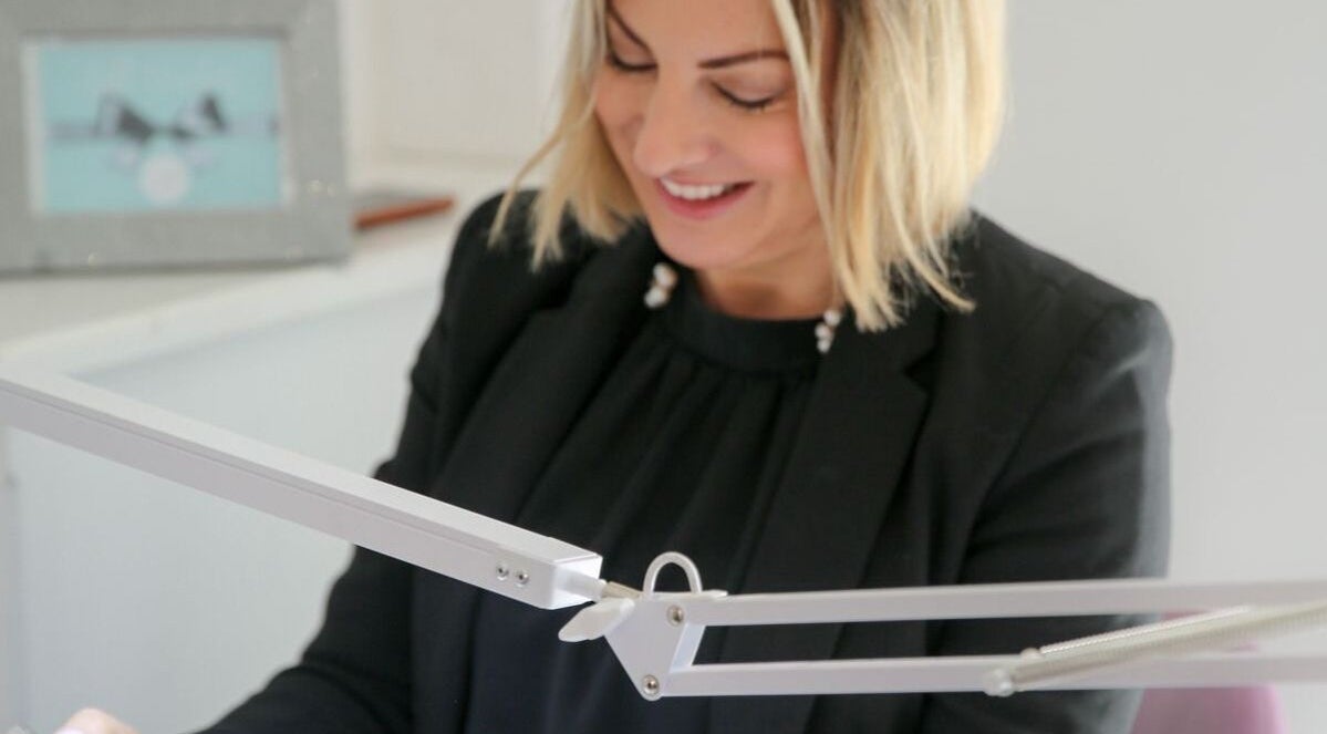 Smiling stylist working at Bridie’s Beauty at Flutterbye Lashes, Lowestoft, England, GB.