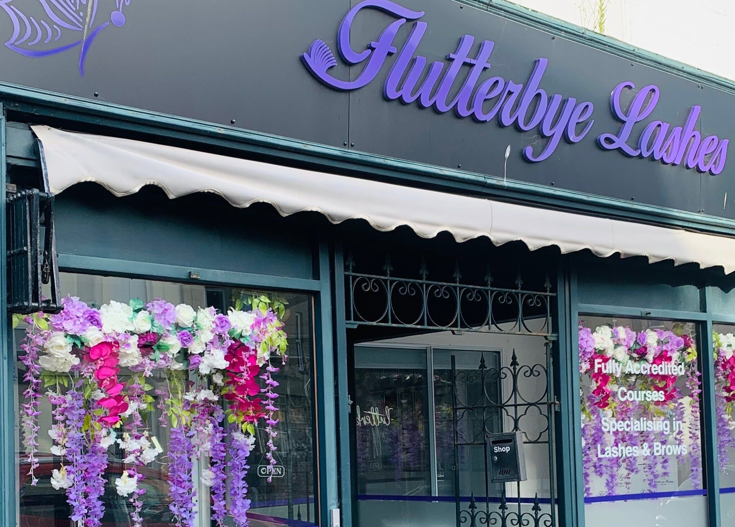 Front view of Bridie’s Beauty at Flutterbye Lashes, Lowestoft, England, GB with floral decorations.