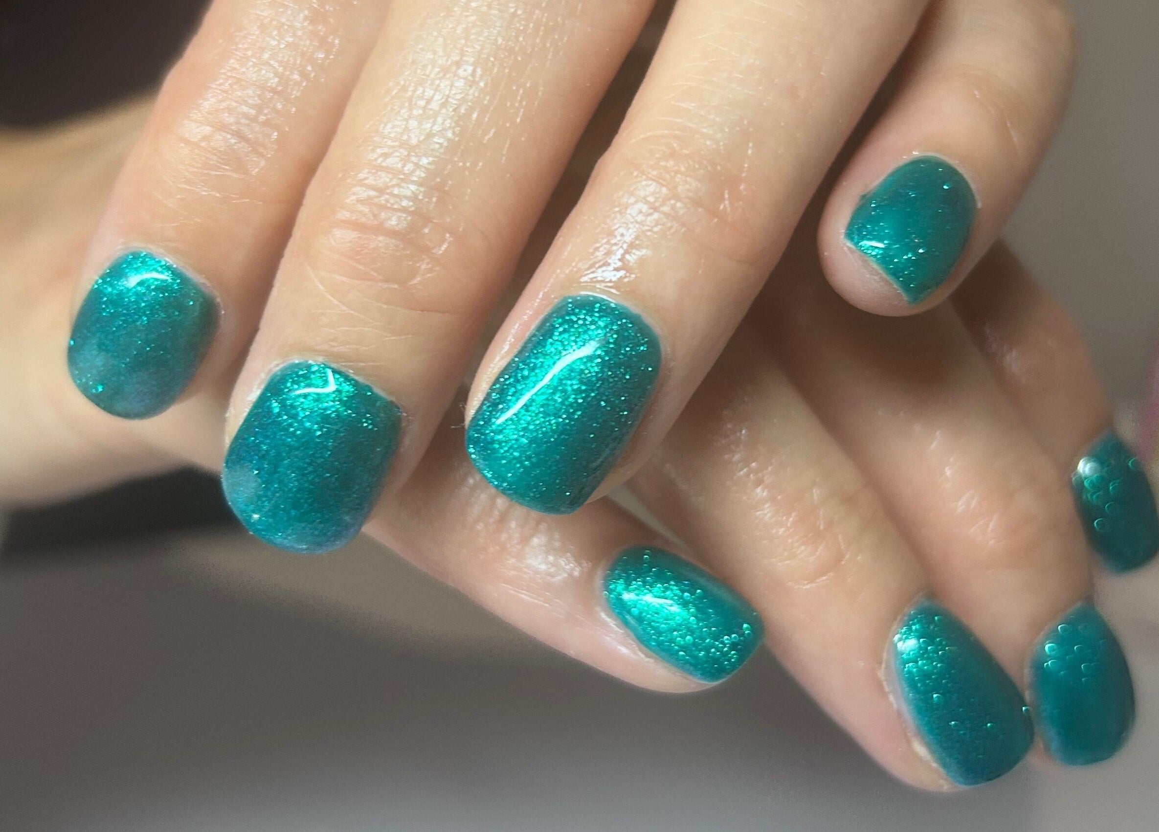 Vibrant teal nails at Bridie’s Beauty, Flutterbye Lashes in Lowestoft, England, GB, showcasing a flawless manicure.