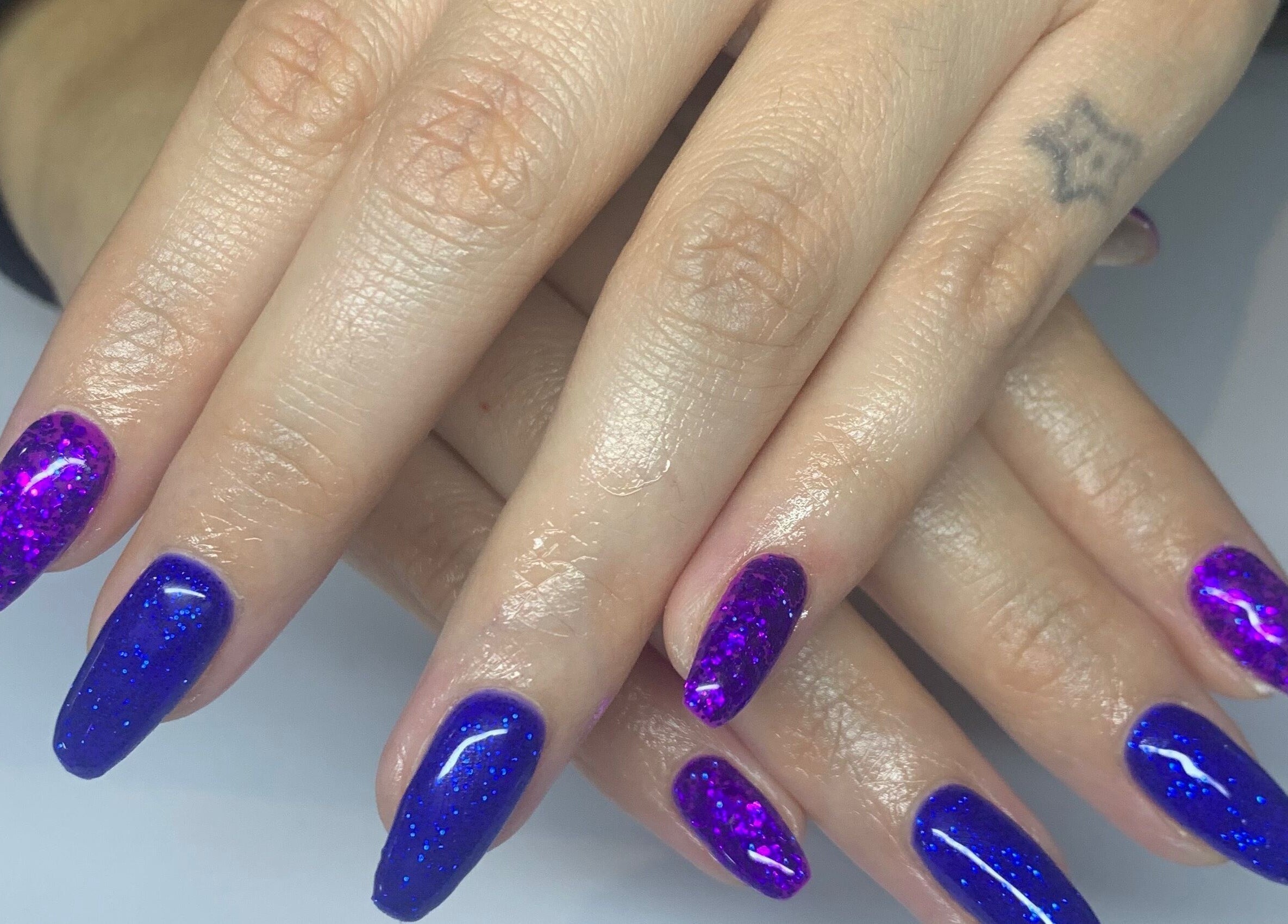 Sparkling blue and purple nails at Bridie's Beauty at Flutterbye Lashes, Lowestoft, England, GB.