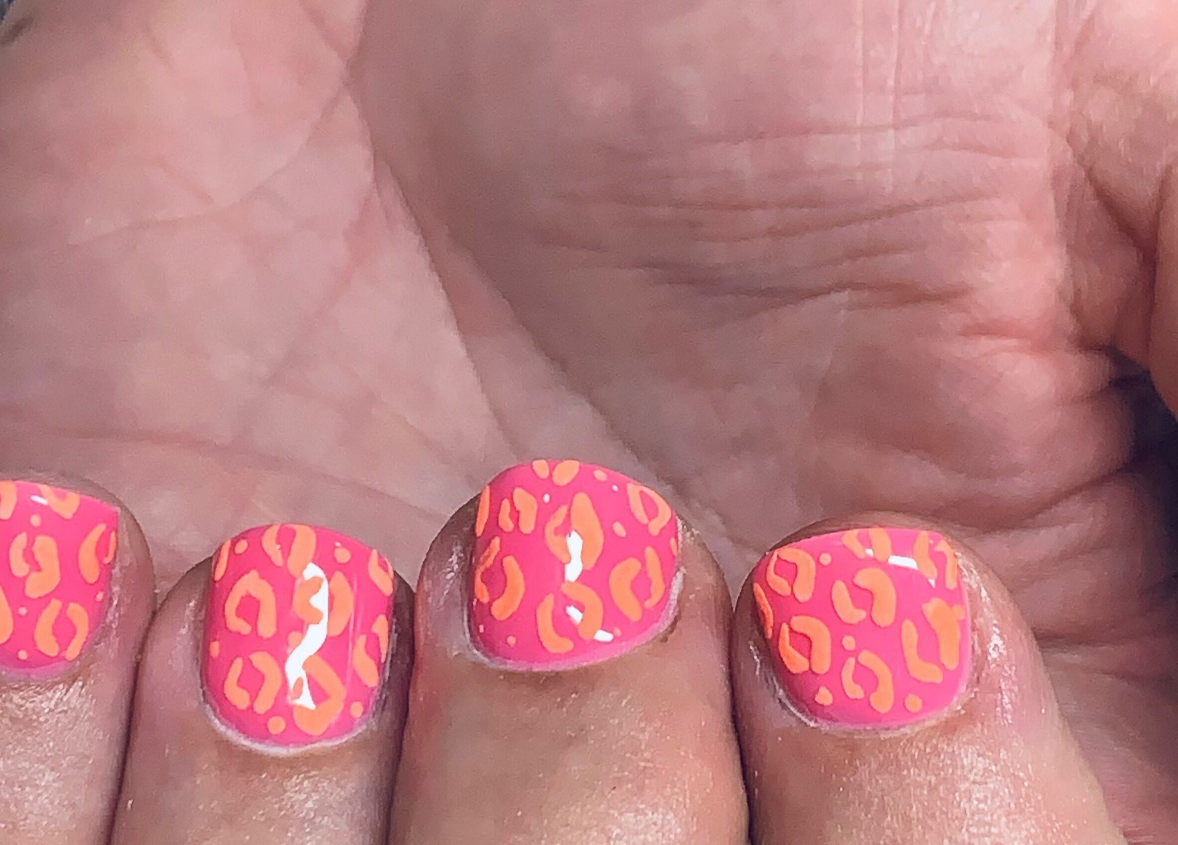 Bright pink and orange leopard nail design at Bridie’s Beauty at Flutterbye Lashes, Lowestoft, England, GB.