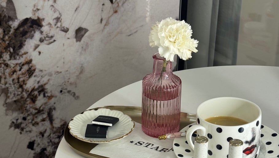 Chic decor at STARR beautyspace in Tallinn, Harju maakond, EE featuring a pink vase and a polka dot cup.