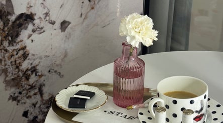 Chic decor at STARR beautyspace in Tallinn, Harju maakond, EE featuring a pink vase and a polka dot cup.