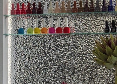 Nail polish display at STARR beautyspace, Tallinn, Harju maakond, EE with vibrant colors against textured wall.