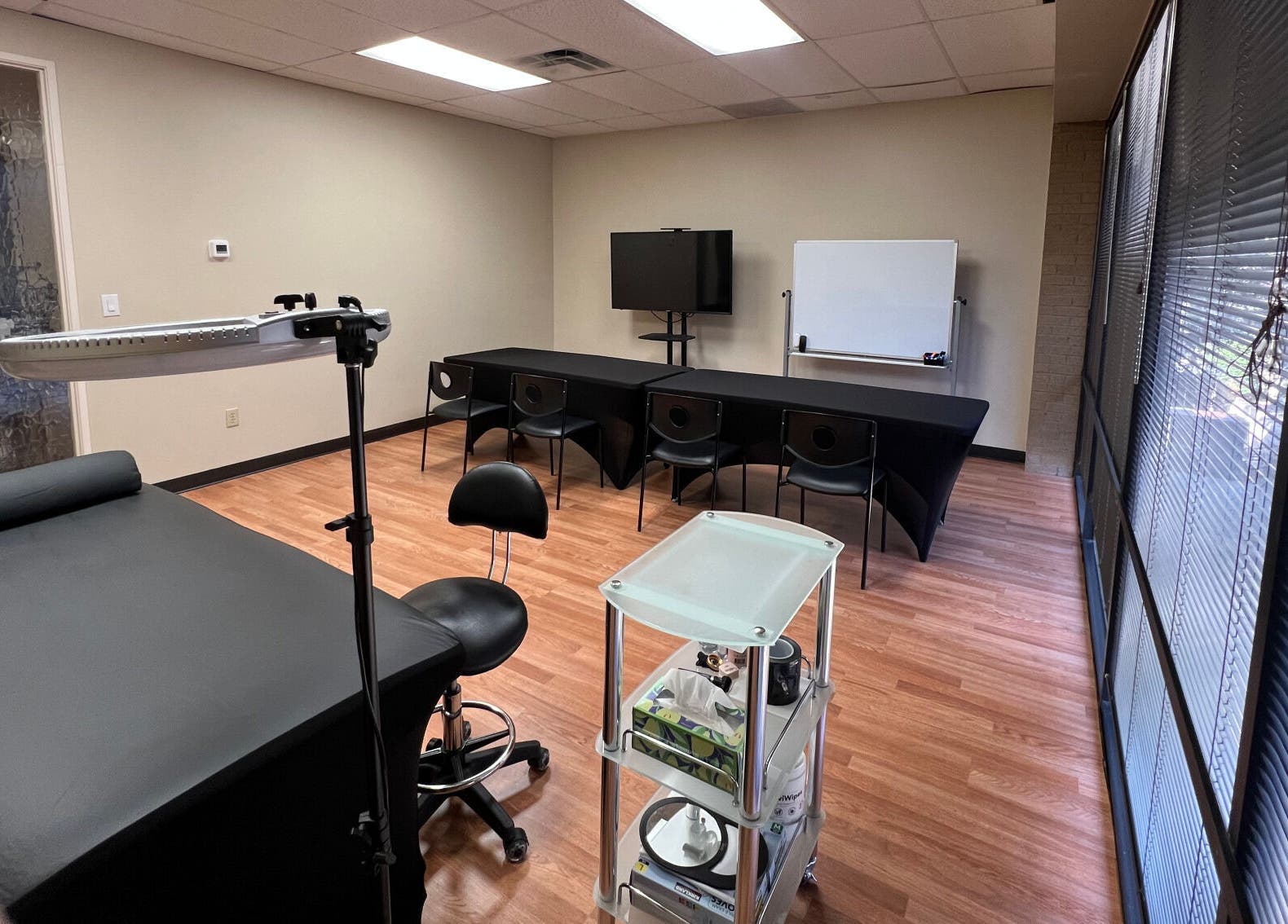 Training room at 5 Star Academy, Dallas, Texas, US with tables, chairs, and lighting equipment.