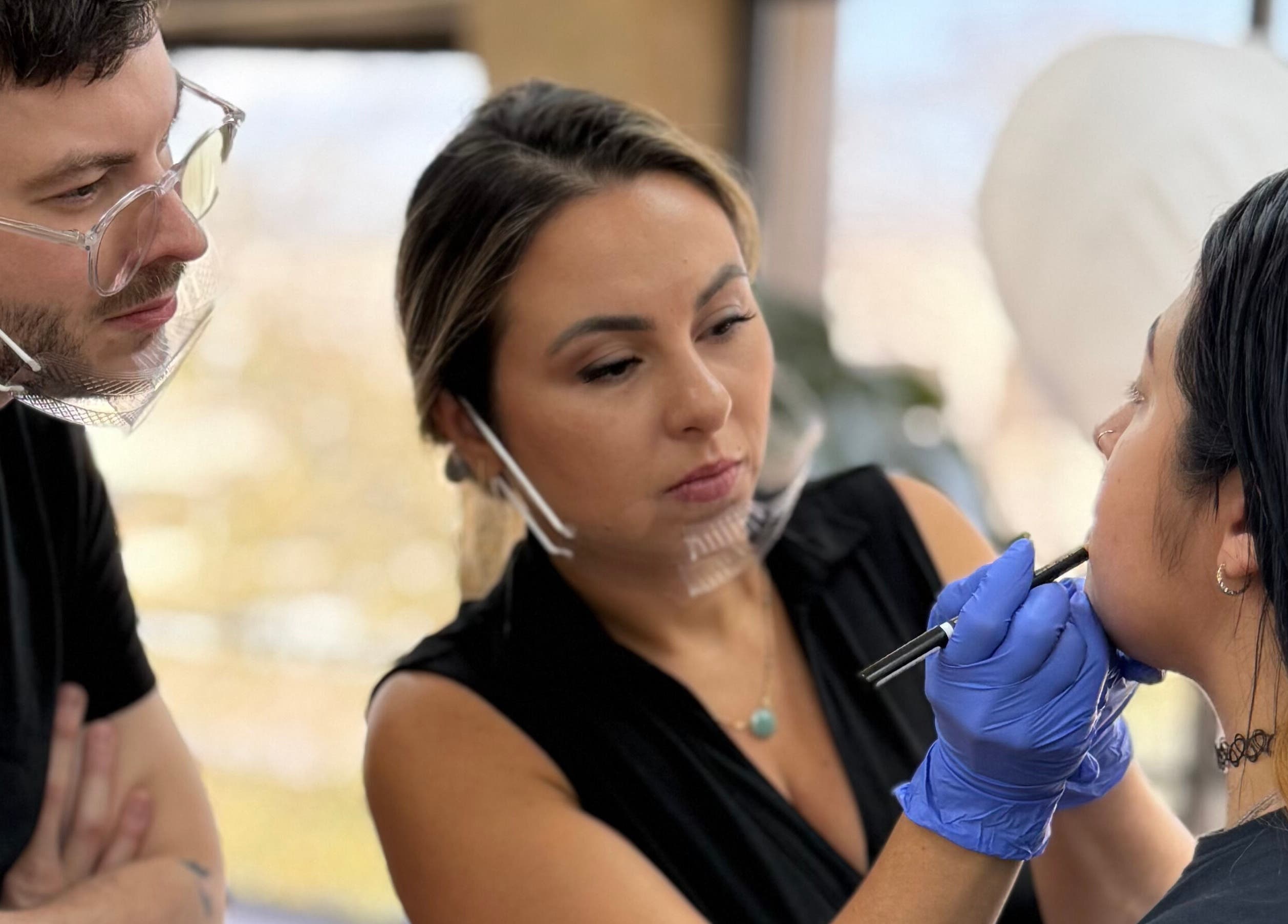 5 Star Academy makeup artist applying cosmetics to client in Dallas, Texas, US.