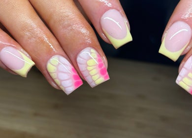Vibrant pastel nail design at Faye Mcc Beauty, Kells, Northern Ireland, GB. Soft pink and yellow hues showcase elegance.