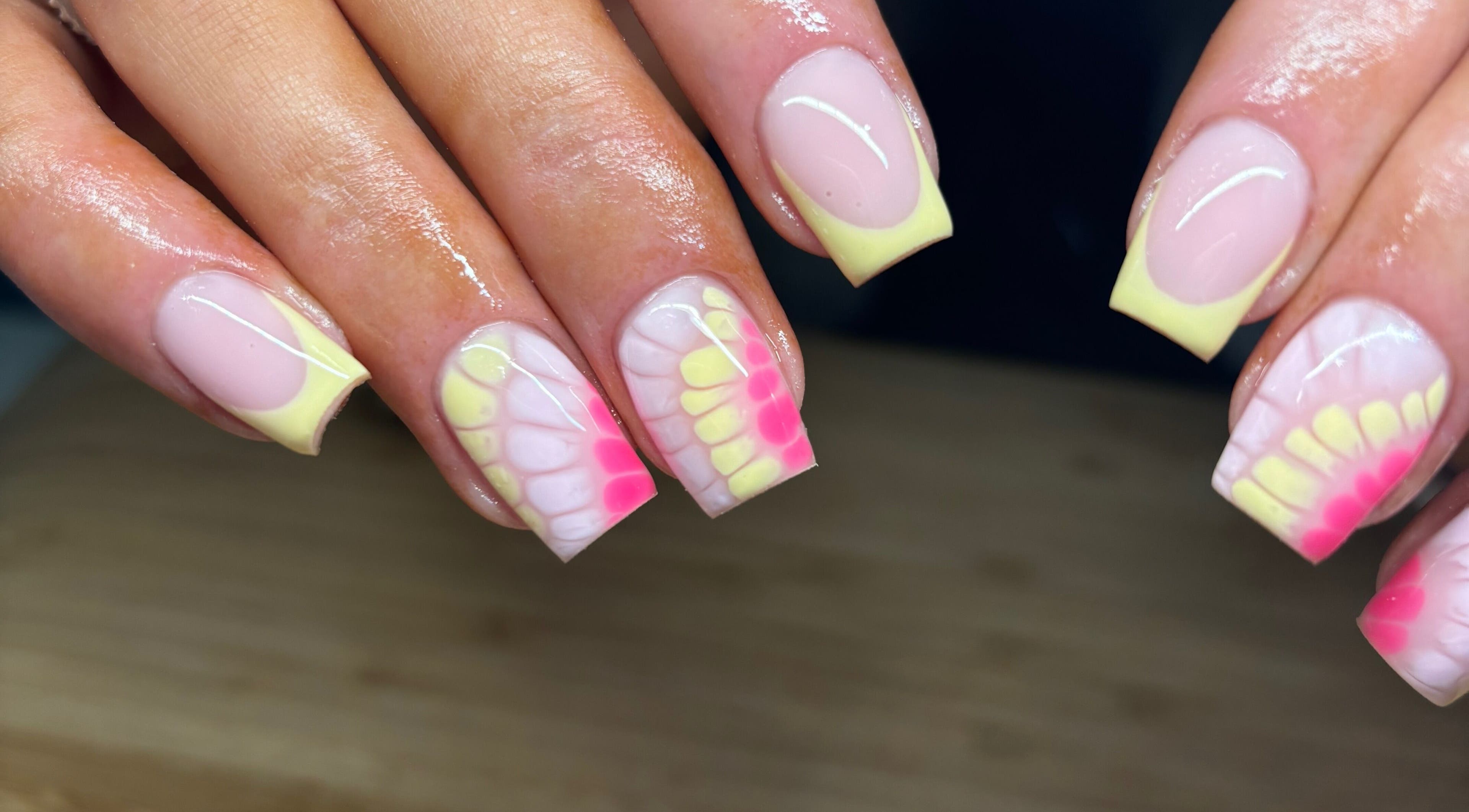 Vibrant pastel nail design at Faye Mcc Beauty, Kells, Northern Ireland, GB. Soft pink and yellow hues showcase elegance.