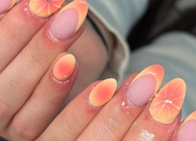 Sunset nail art design at Faye Mcc Beauty, Kells, Northern Ireland, GB, featuring floral patterns and jewel accents.