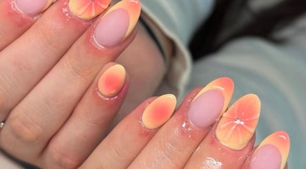Sunset nail art design at Faye Mcc Beauty, Kells, Northern Ireland, GB, featuring floral patterns and jewel accents.