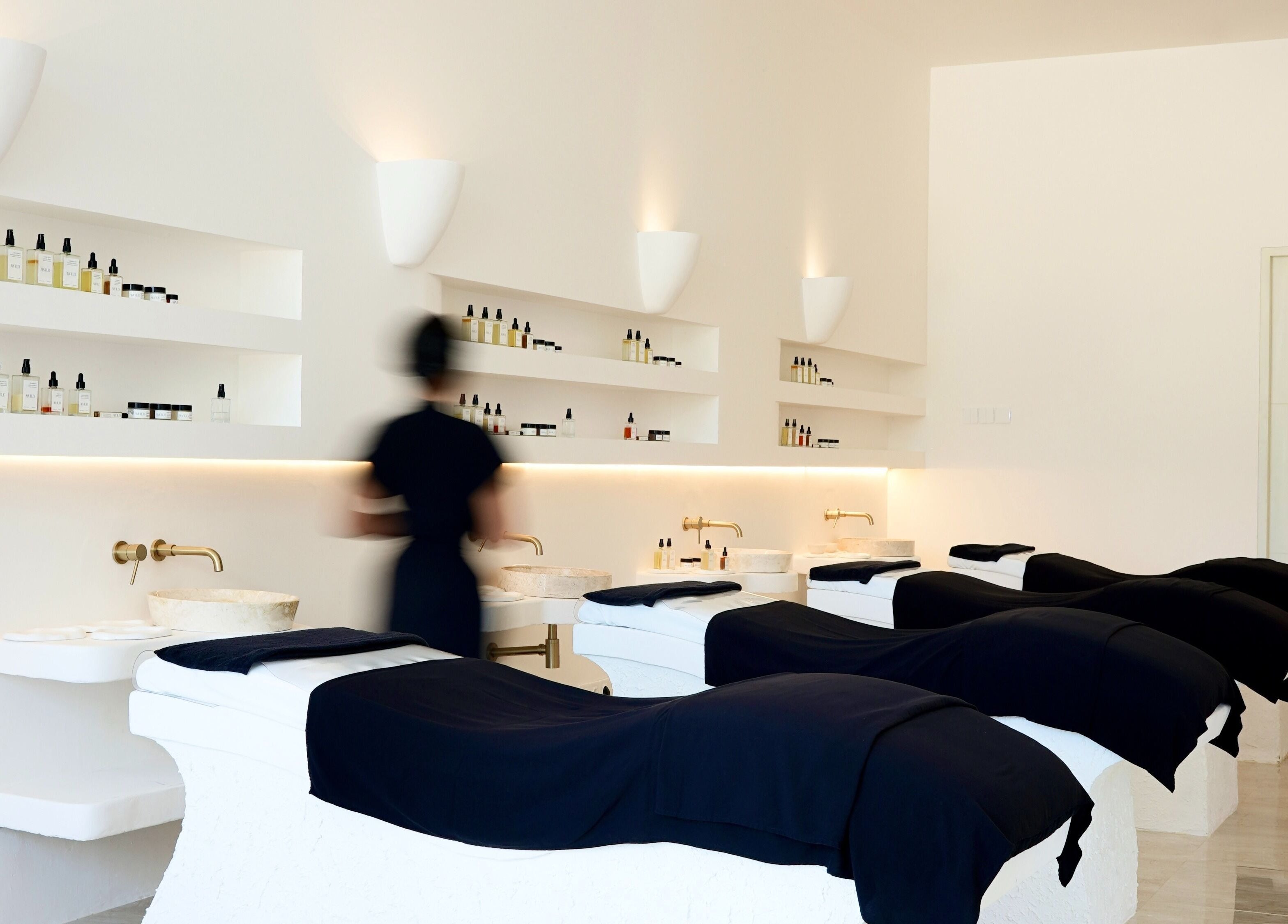 Luxurious treatment room at Awild Facial Uluwatu, Pecatu, Bali, ID with elegant massage tables and products.