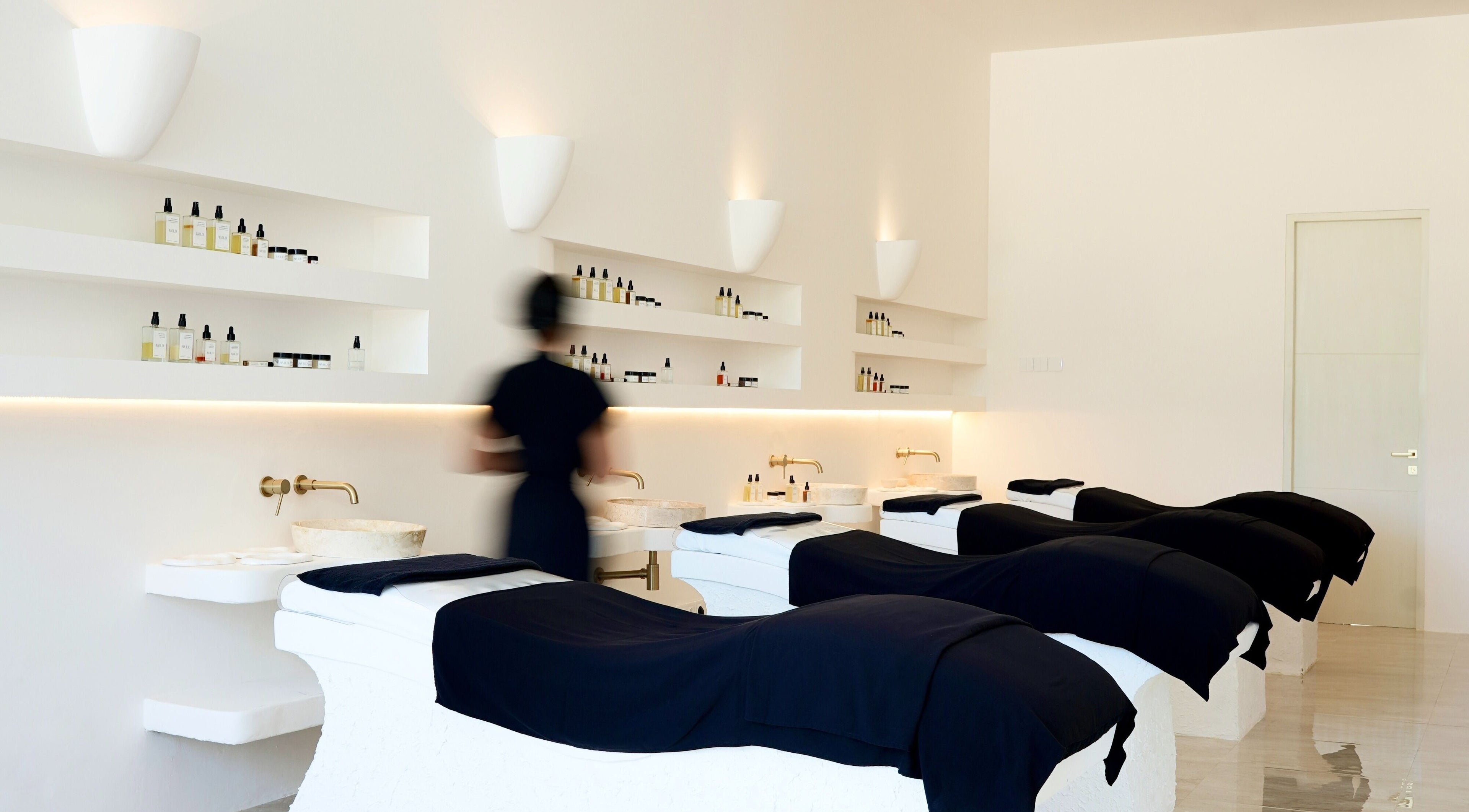 Luxurious treatment room at Awild Facial Uluwatu, Pecatu, Bali, ID with elegant massage tables and products.