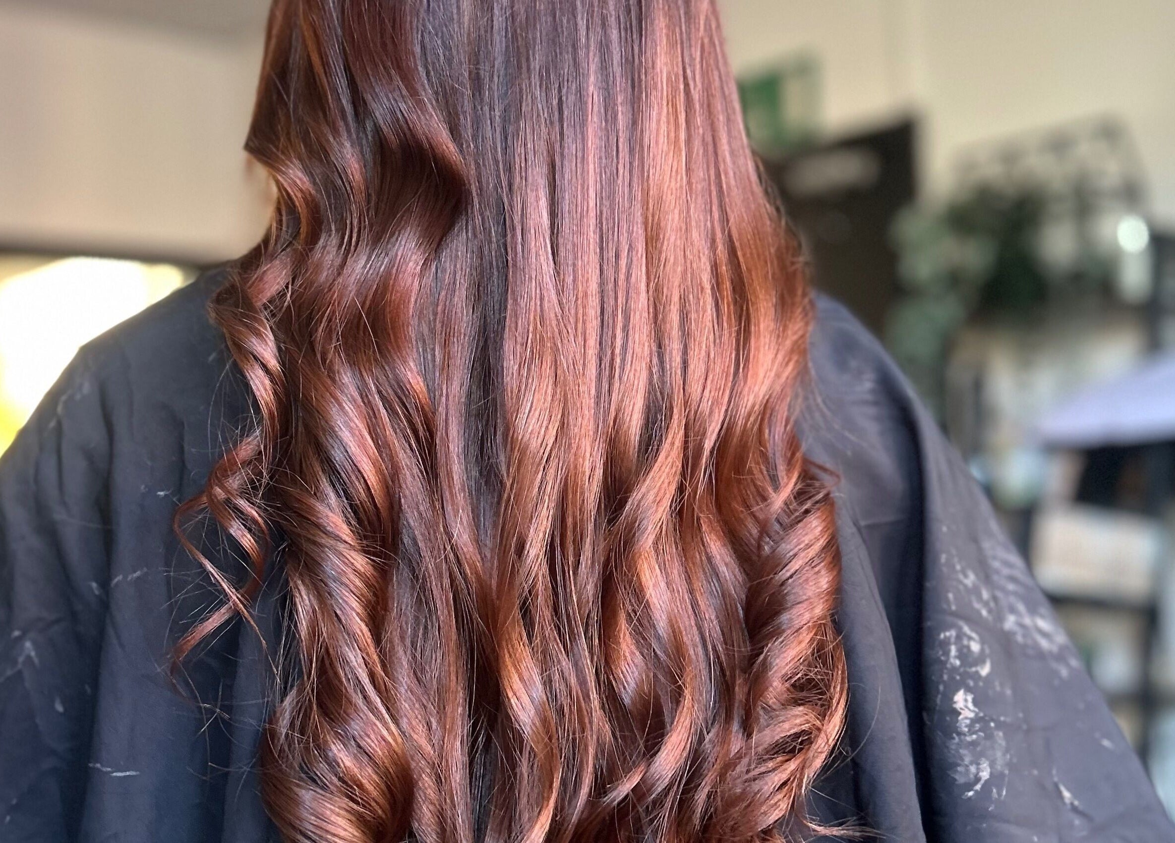 Stylishly curled brown hair at Emily ~ Janes, Doncaster, England, GB salon for a radiant look.