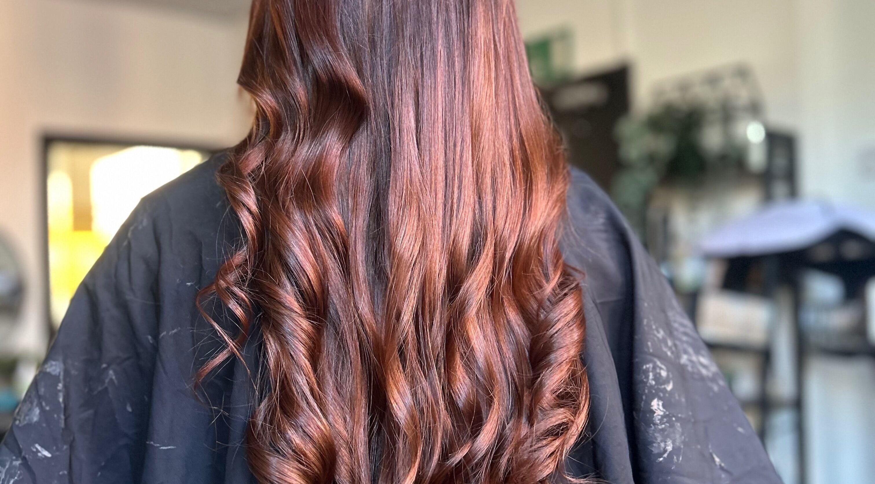 Stylishly curled brown hair at Emily ~ Janes, Doncaster, England, GB salon for a radiant look.