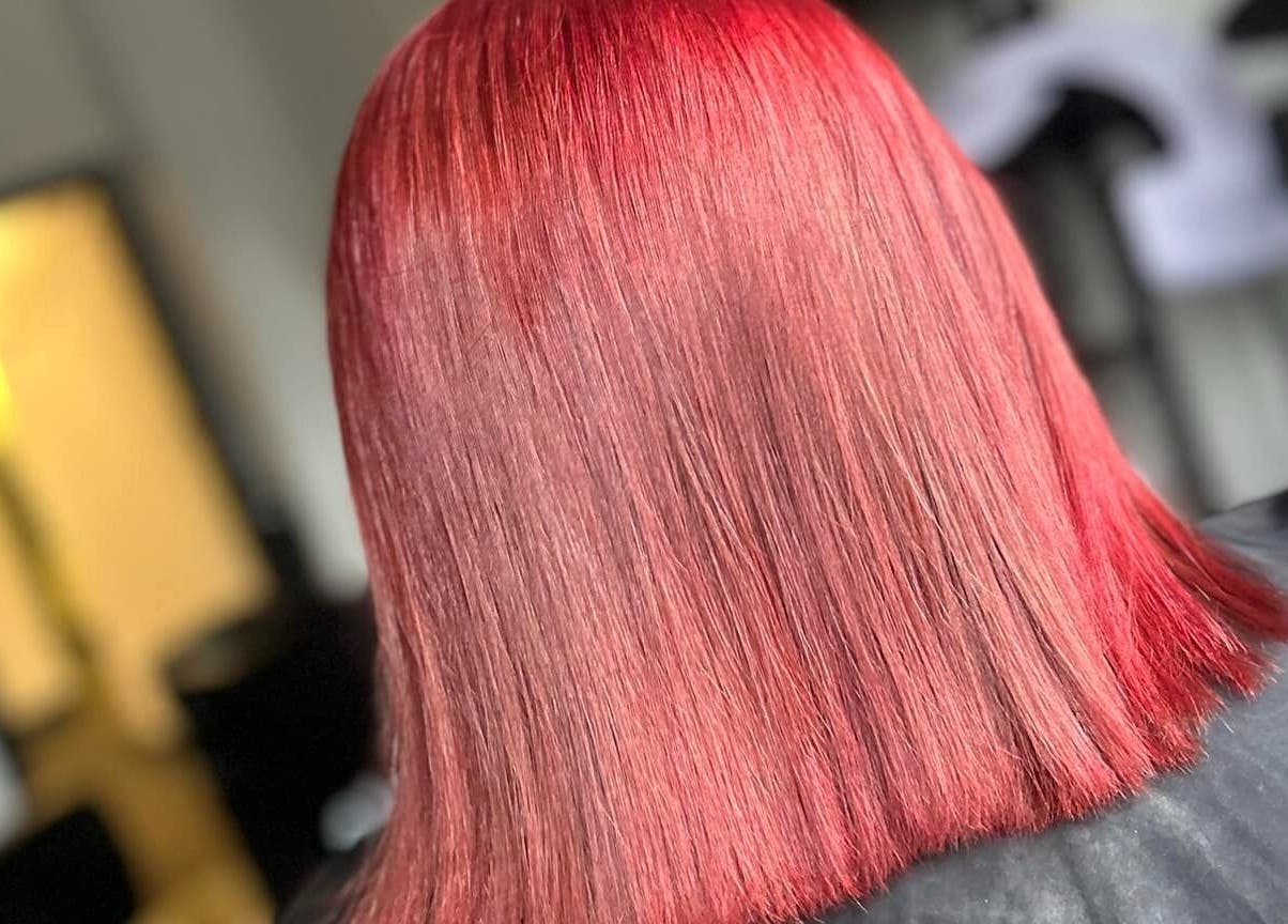 Vibrant red hairstyle at Emily ~ Janes, Doncaster, England, GB, showcasing sleek, glossy hair.
