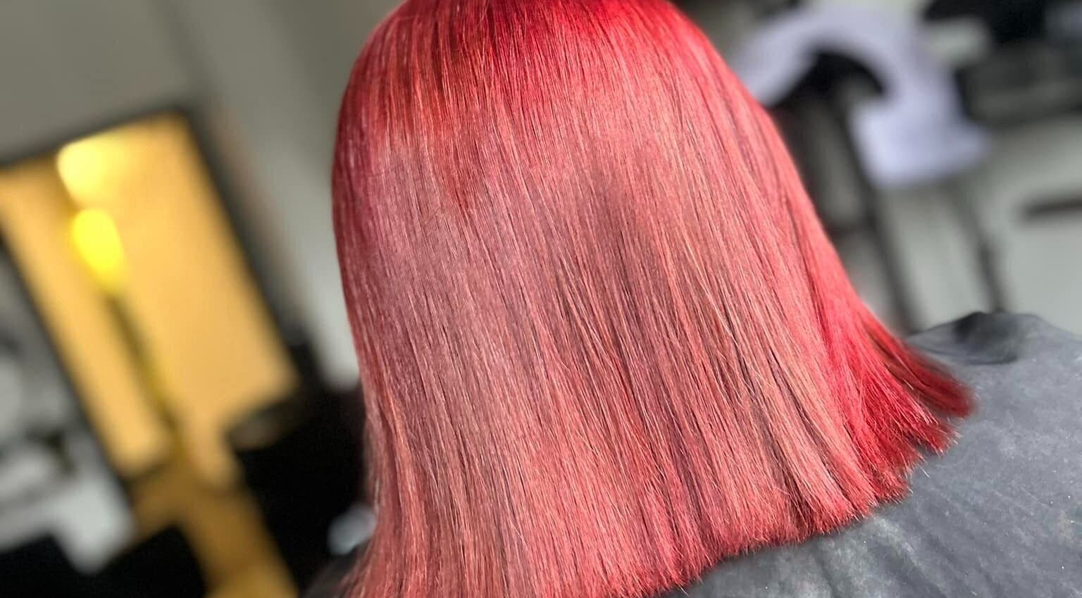 Vibrant red hairstyle at Emily ~ Janes, Doncaster, England, GB, showcasing sleek, glossy hair.