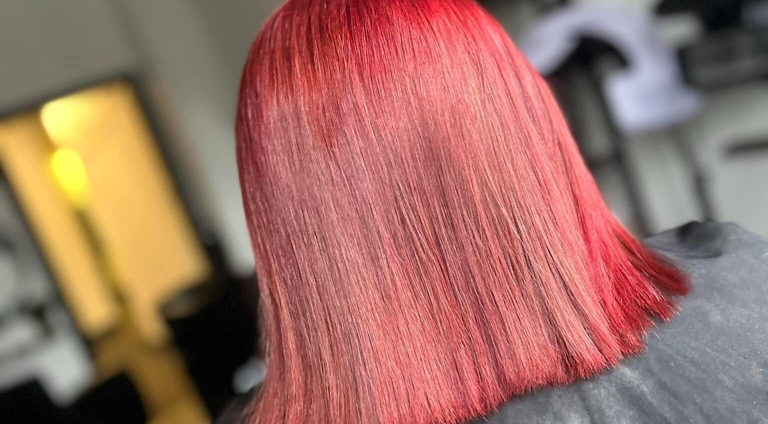 Vibrant red hairstyle at Emily ~ Janes, Doncaster, England, GB, showcasing sleek, glossy hair.