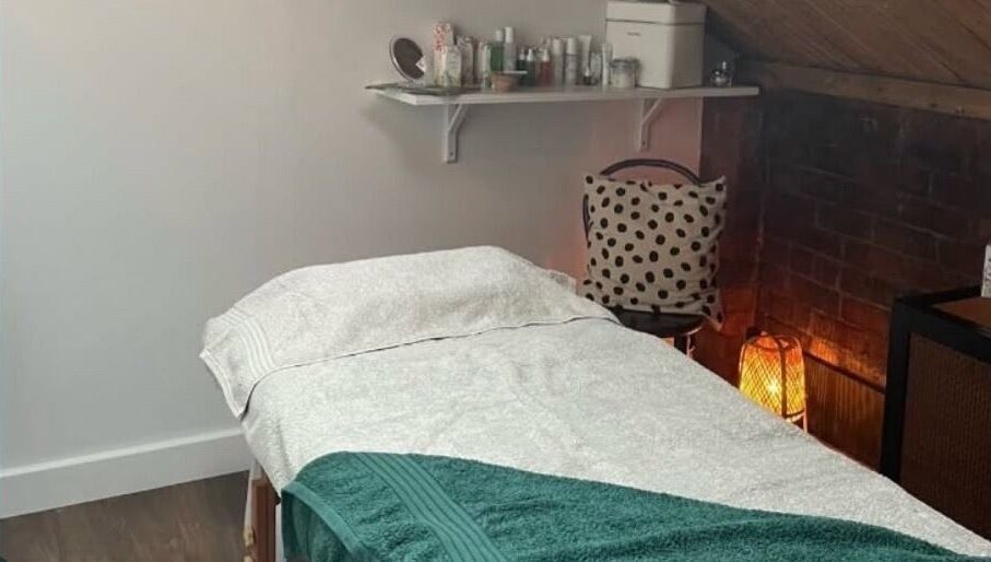 Cozy treatment room at The Sanctuary at Sass, Marsden, England, GB with massage table and ambient lighting.