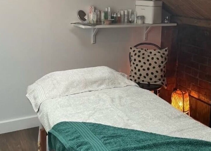 Cozy treatment room at The Sanctuary at Sass, Marsden, England, GB with massage table and ambient lighting.