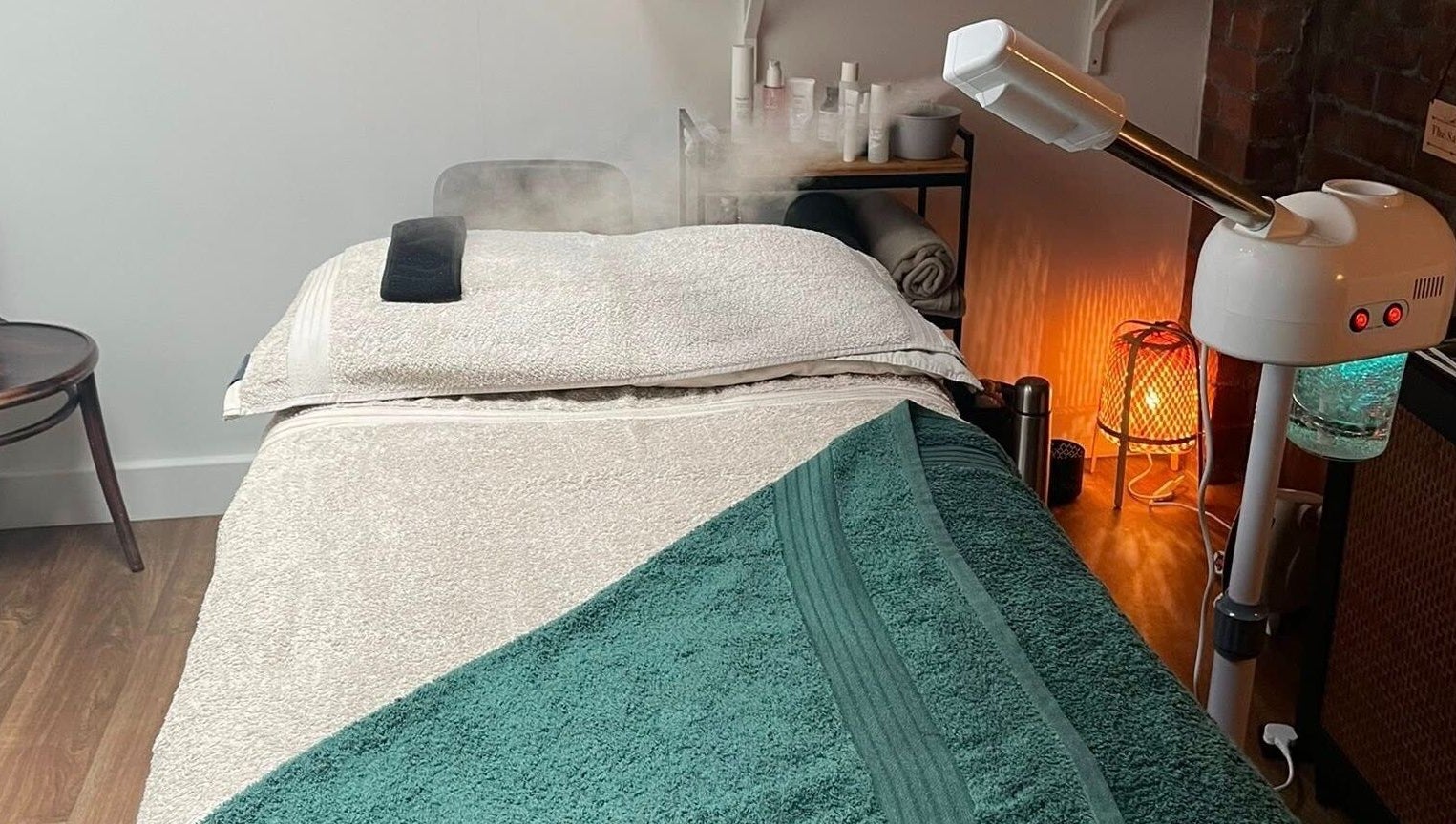 Massage room at The Sanctuary at Sass, Marsden, England, GB, showcasing a cozy massage table and spa equipment.