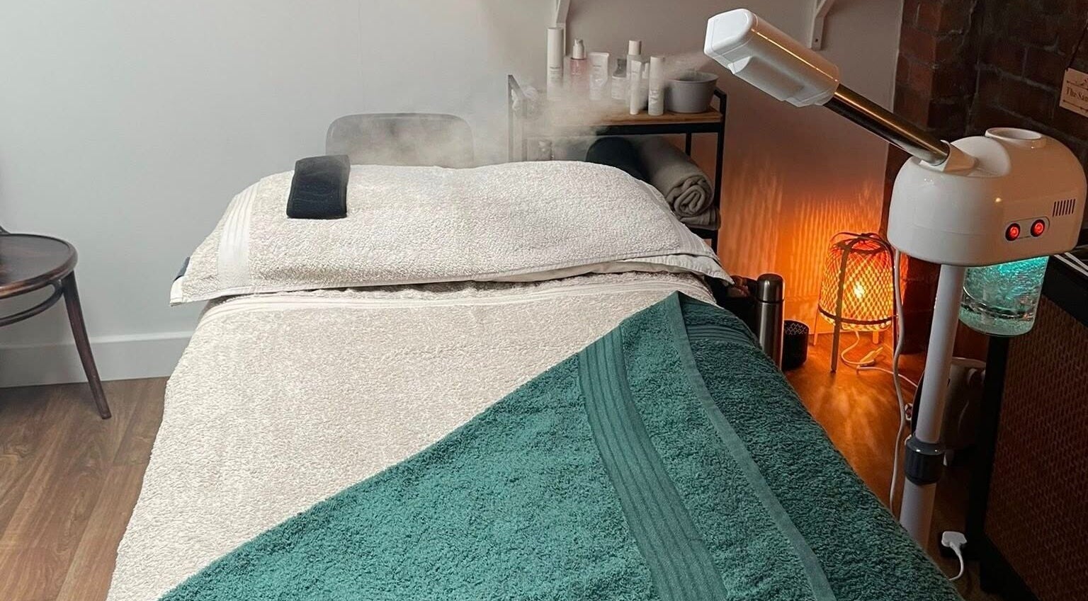 Massage room at The Sanctuary at Sass, Marsden, England, GB, showcasing a cozy massage table and spa equipment.