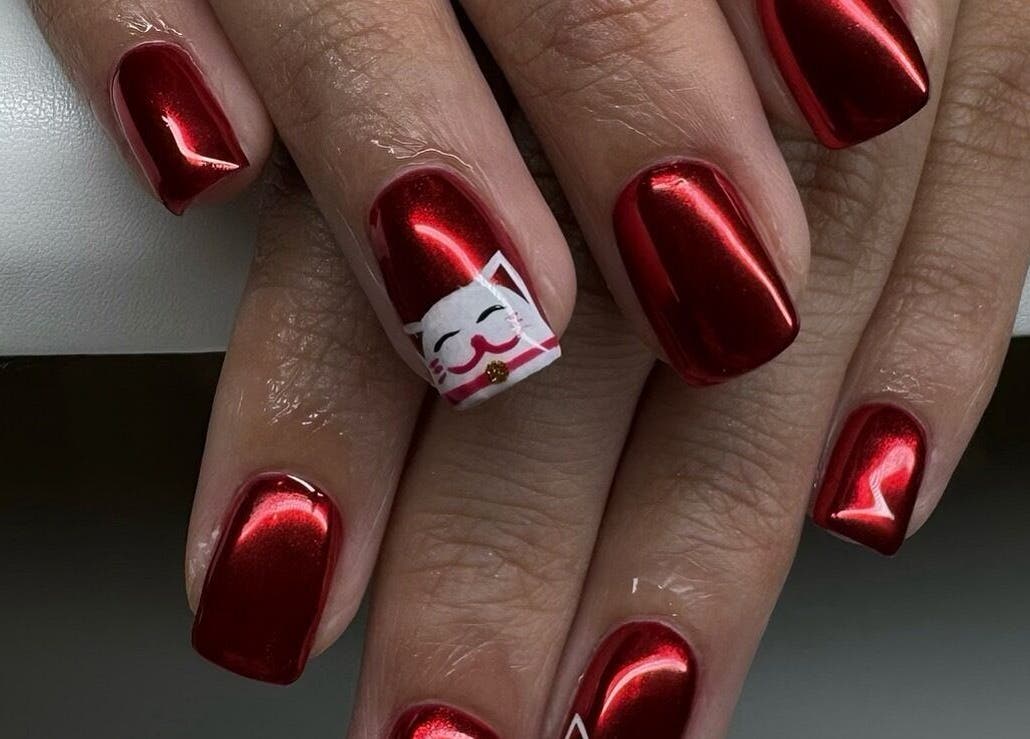 Vibrant red manicure with cat design at Miso Nail Studio, North Rocks, New South Wales, AU.