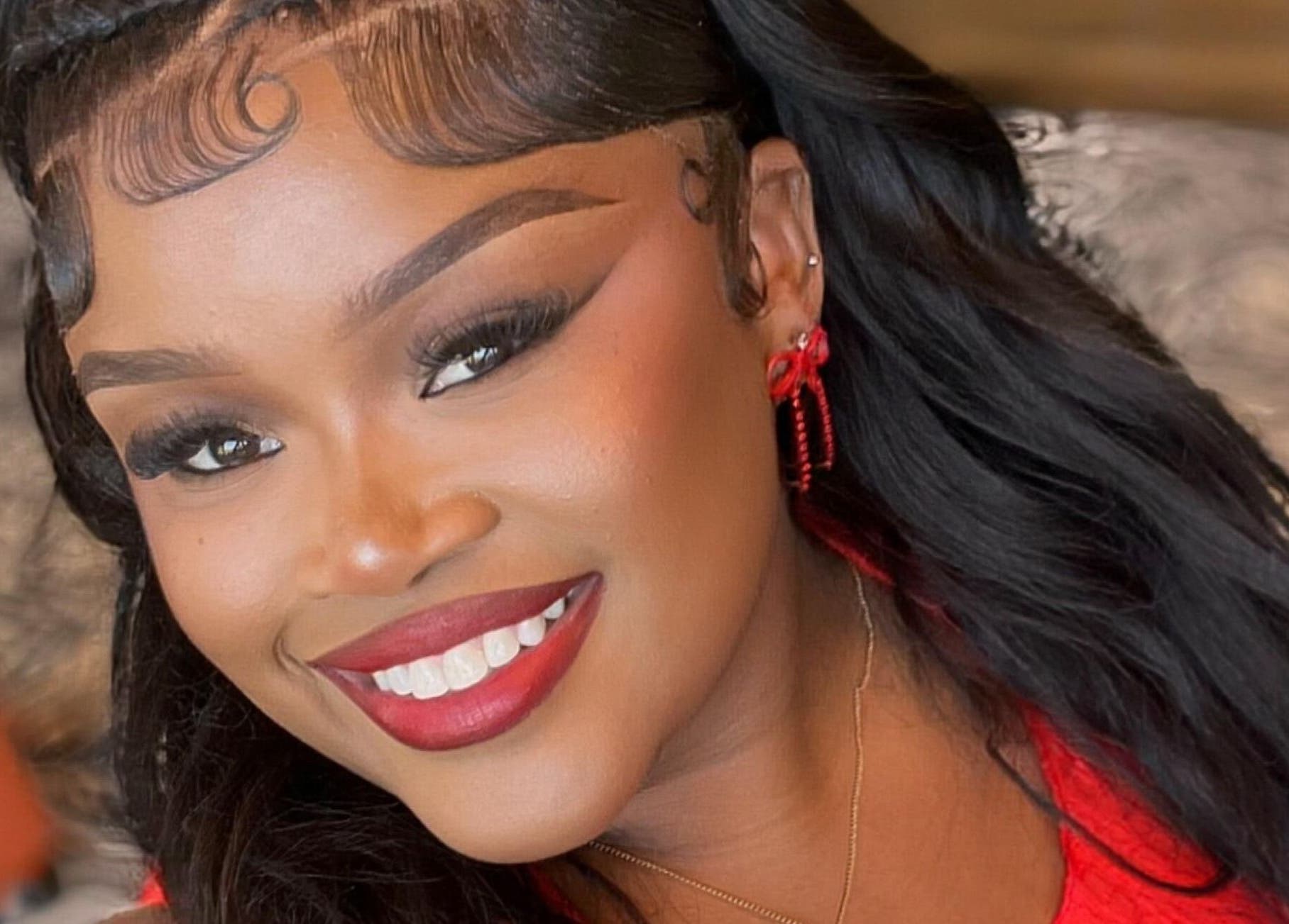 Smiling woman showcasing vibrant makeup at Lashesbymisspee, Cape Town, Western Cape, ZA.