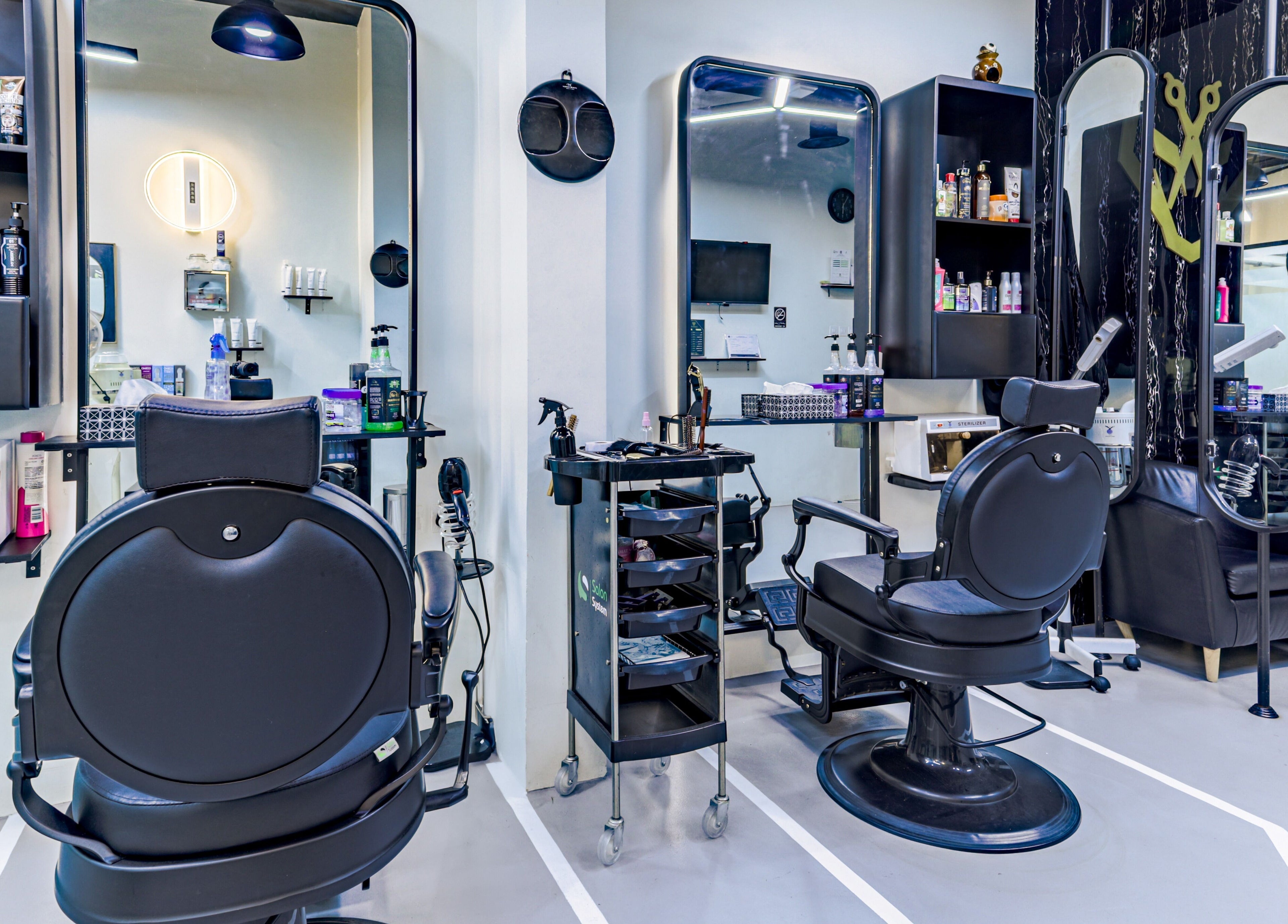 Modern salon interior at The Diamond Wolf, Riyadh, Riyadh Province, SA, featuring sleek black styling chairs.