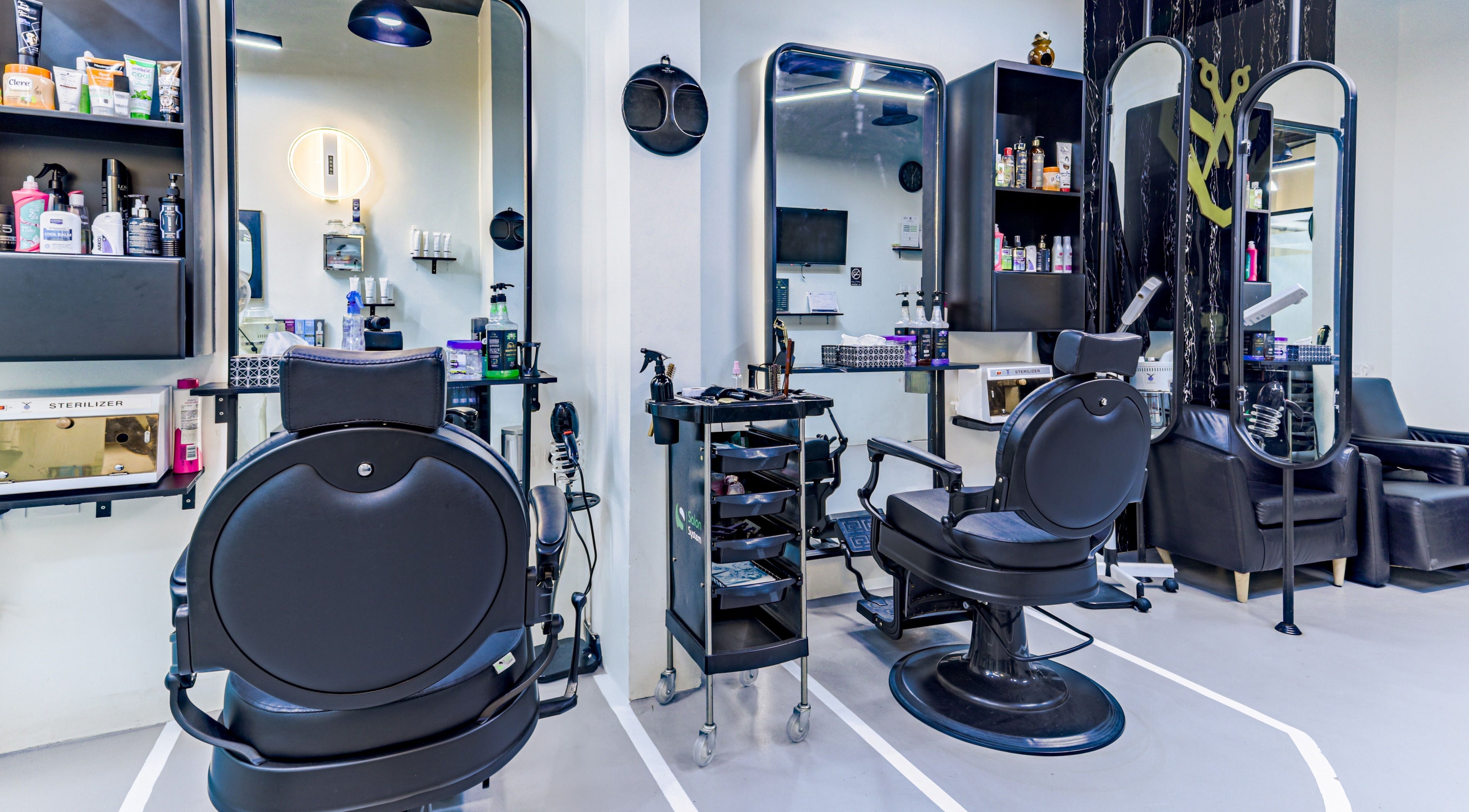 Modern salon interior at The Diamond Wolf, Riyadh, Riyadh Province, SA, featuring sleek black styling chairs.