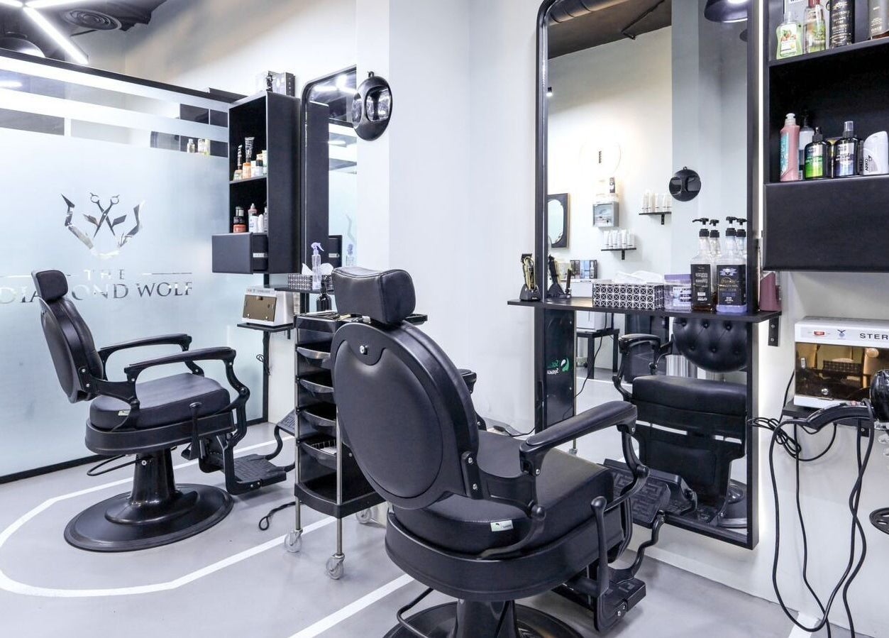 Modern salon interior at The Diamond Wolf, Riyadh, Riyadh Province, SA, featuring sleek black chairs and mirrors.